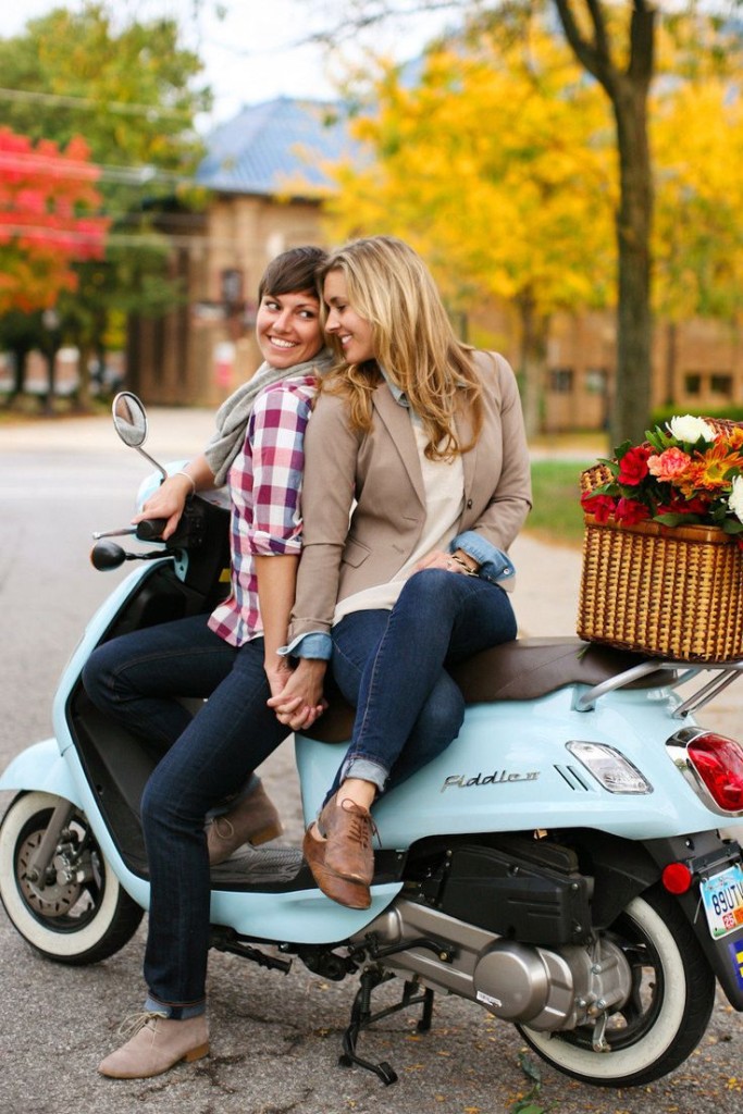 Gay couple on bike posing for engagement photo