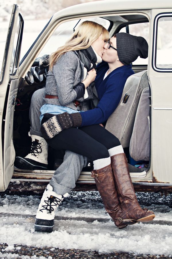 Couple in a car in the winter kissing for engagement photo shoot
