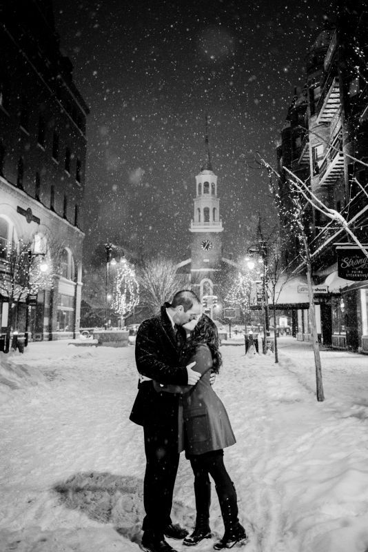Couple in the snow having engagement photos taken