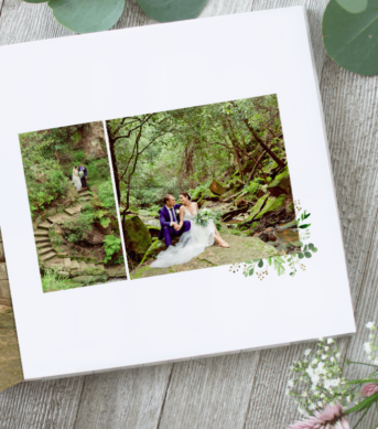 Wedding photo album featuring a couple in a nature scene with greenery, sitting on stone steps and forest surroundings.