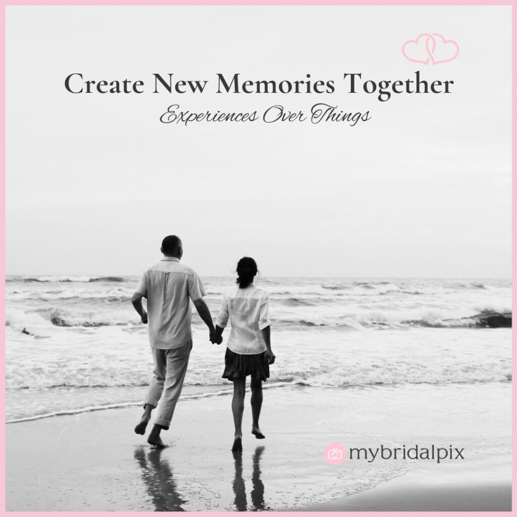 Black and white photo of a couple walking on a beach. The text reads "Create New Memories Together. Experiences Over Things." as part of first wedding anniversary gift ideas and inspirations.