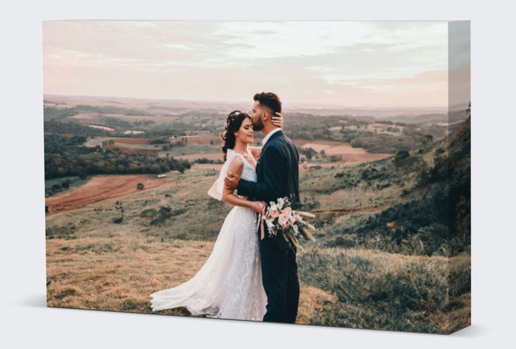 An image of two people, bride and the groom, standing in the field.