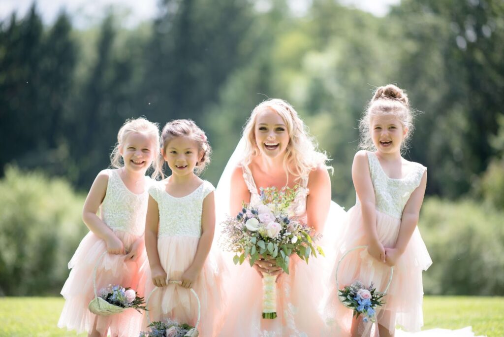 flower girls having a fun time with a bride