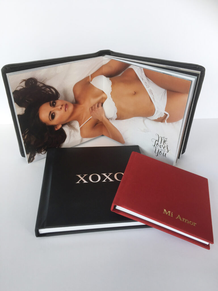 Image of an open photo book with a woman in lingerie and two closed books labeled "XOXO" and "Mi Amor," focusing on boudoir photography.